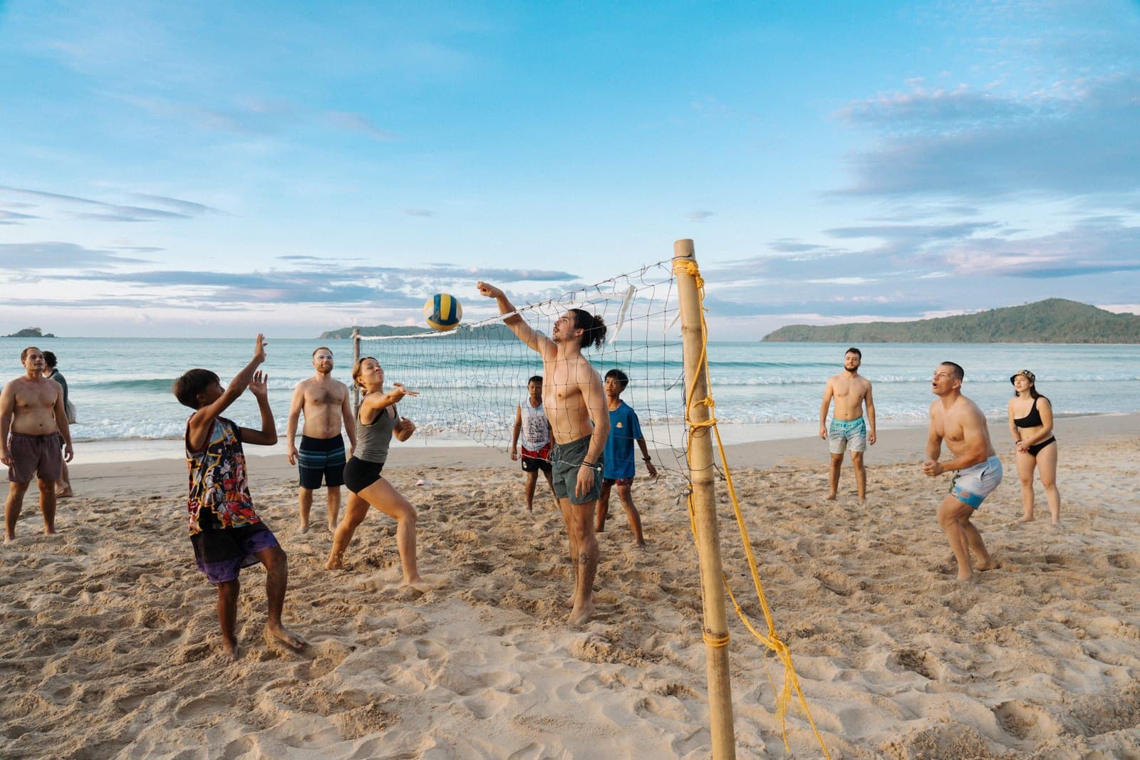 Guests playing beach volleyball on the sand